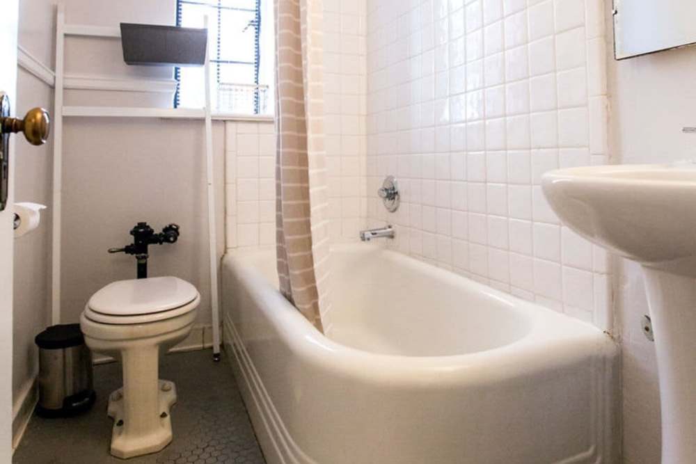 Bathroom with a bathtub and a sink at Historic Boylan Apartments in Raleigh, North Carolina