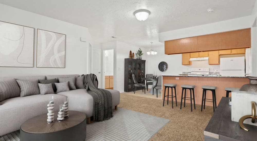 A furnished apartment living room and kitchen at Stonebridge Apartments in West Jordan, Utah