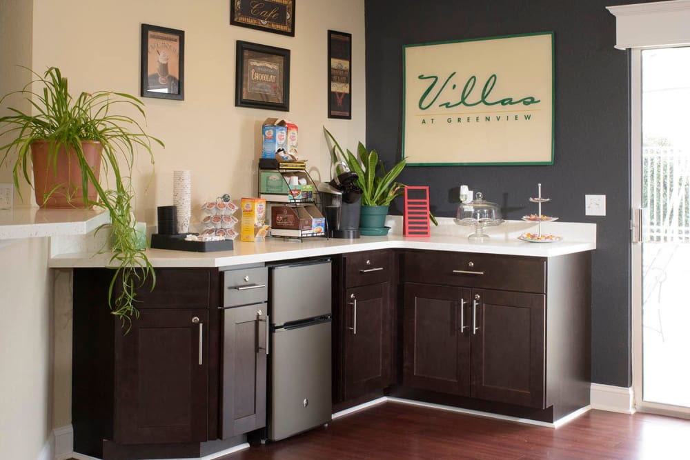 A coffee bar with plenty of condiments at Villas at Greenview West in Great Mills, Maryland