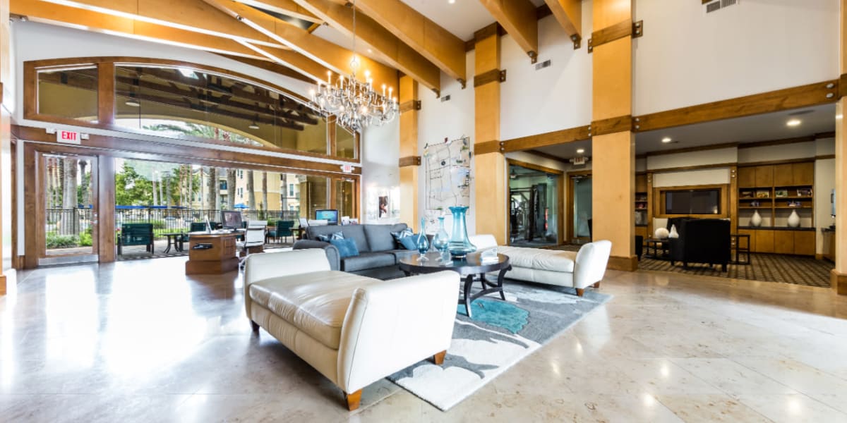 Community clubhouse lobby sitting area with view of the pool at Marquis at Clear Lake in Webster, Texas