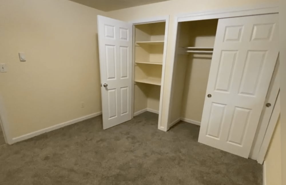 Bedroom with closet storage at Ridgewood Apartments