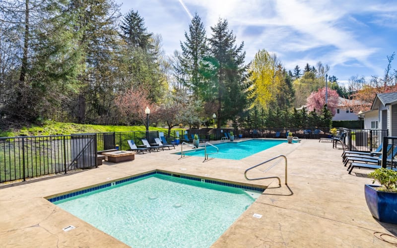 Large bright blue swimming pool at Pebble Cove Apartments in Renton, Washington