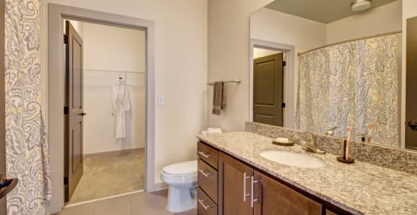 Bathroom with a walk-in closet and oversize vanity at Duet in Nashville, Tennessee