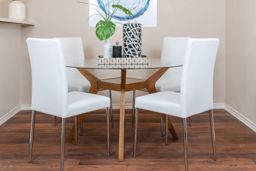 Charming dining area featuring a sleek glass table and modern decor at Charter Oak in Euless, Texas.