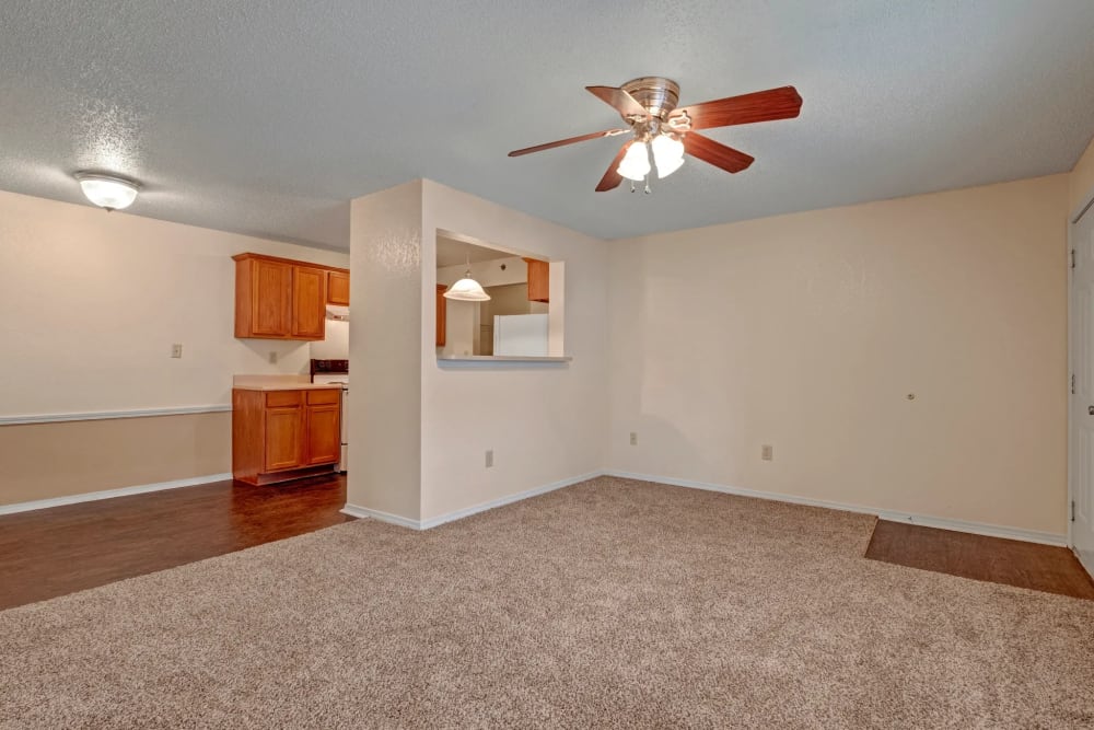 Spacious living area with high ceilings and carpet flooring at Yukon on 15th in Yukon, Oklahoma