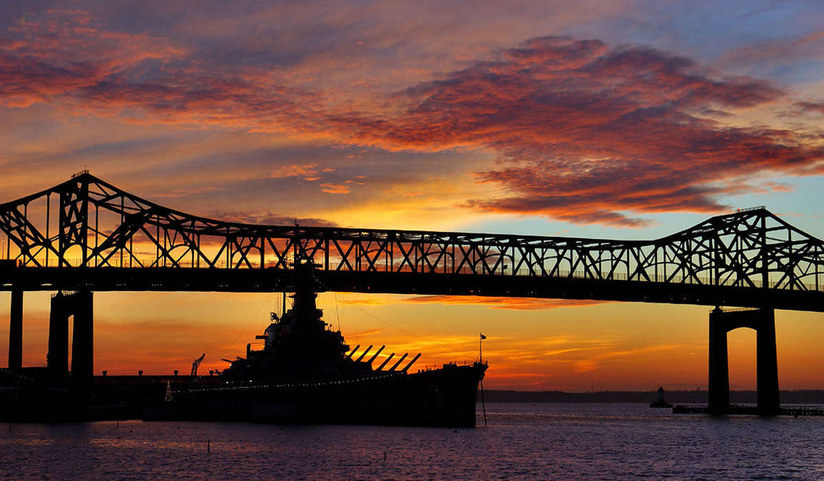 Luxury bridge silhouette against a colorful sunset at Commonwealth Landing Lofts in Fall River, Massachusetts