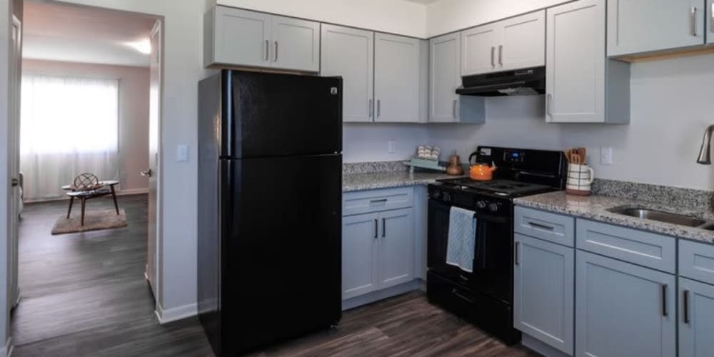 Apartment kitchen with black appliances at Amber Grove Apartments in Marietta, Georgia