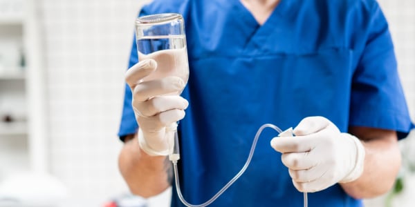 Nurse setting up an IV for a resident in hospice care at Edgerton Care Center in Edgerton, Wisconsin