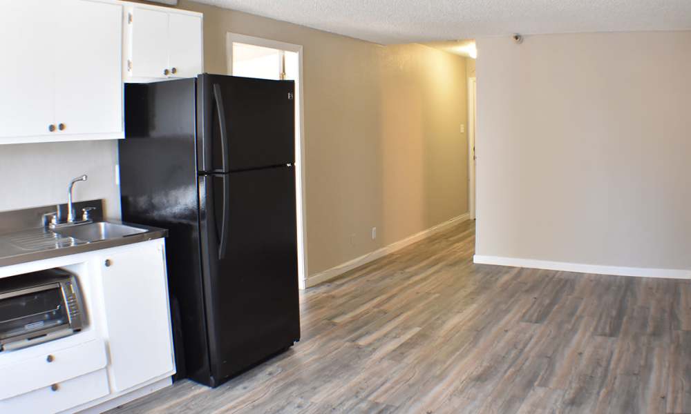 Kitchen with appliances and wood-style flooring at Truckee River Terrace in Reno, Nevada