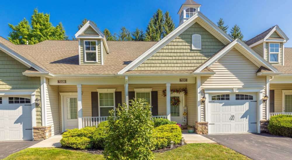 Property exterior with white architecture at Carriages At Cedar Rock in Webster, New York