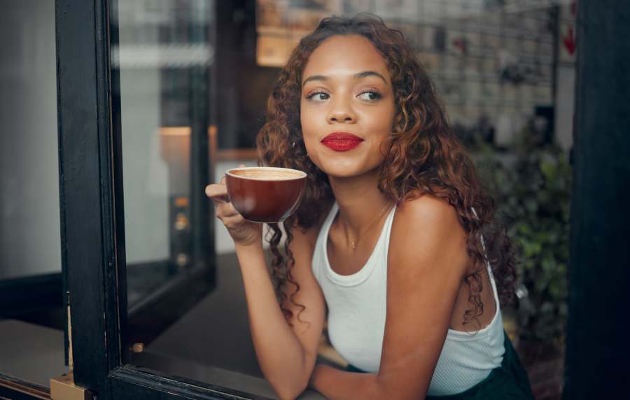 Woman enjoying coffee at café near Balcones Trails in Kyle, Texas