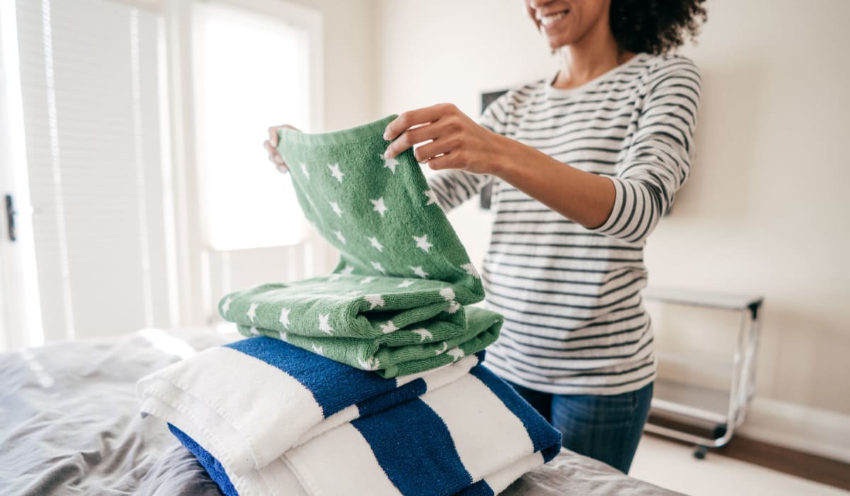 A resident folds laundry in her apartment at Commons on Potomac Square, Sterling, Virginia