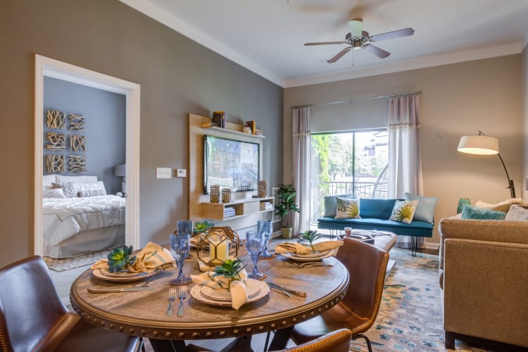 Well-furnished model home's dining and living area at Celsius Apartment Homes in Charlotte, North Carolina