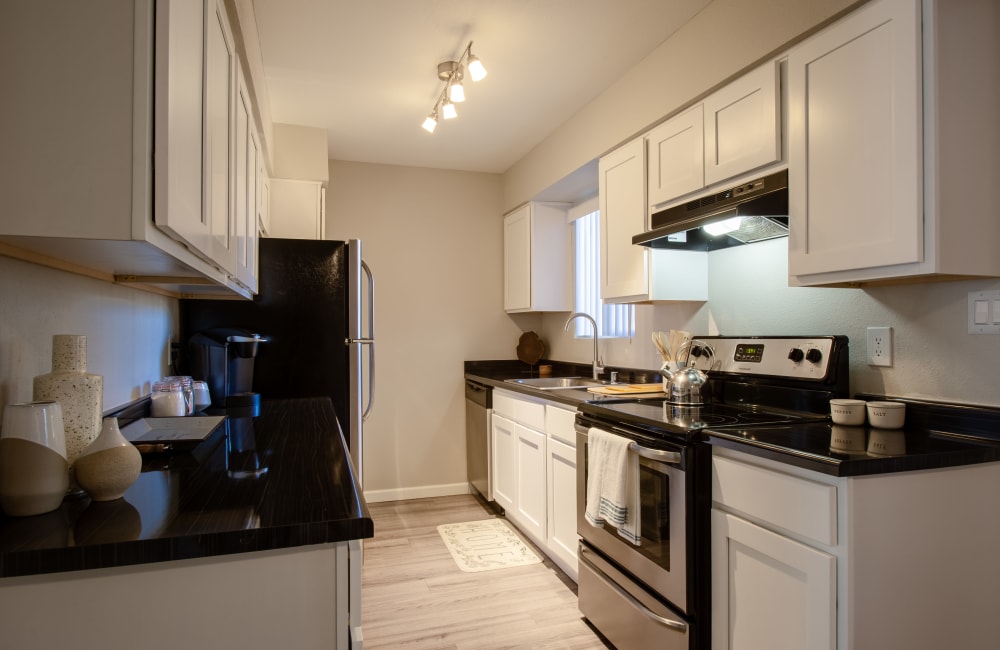 Modern kitchen with black countertops at  Montecito in Albuquerque, New Mexico