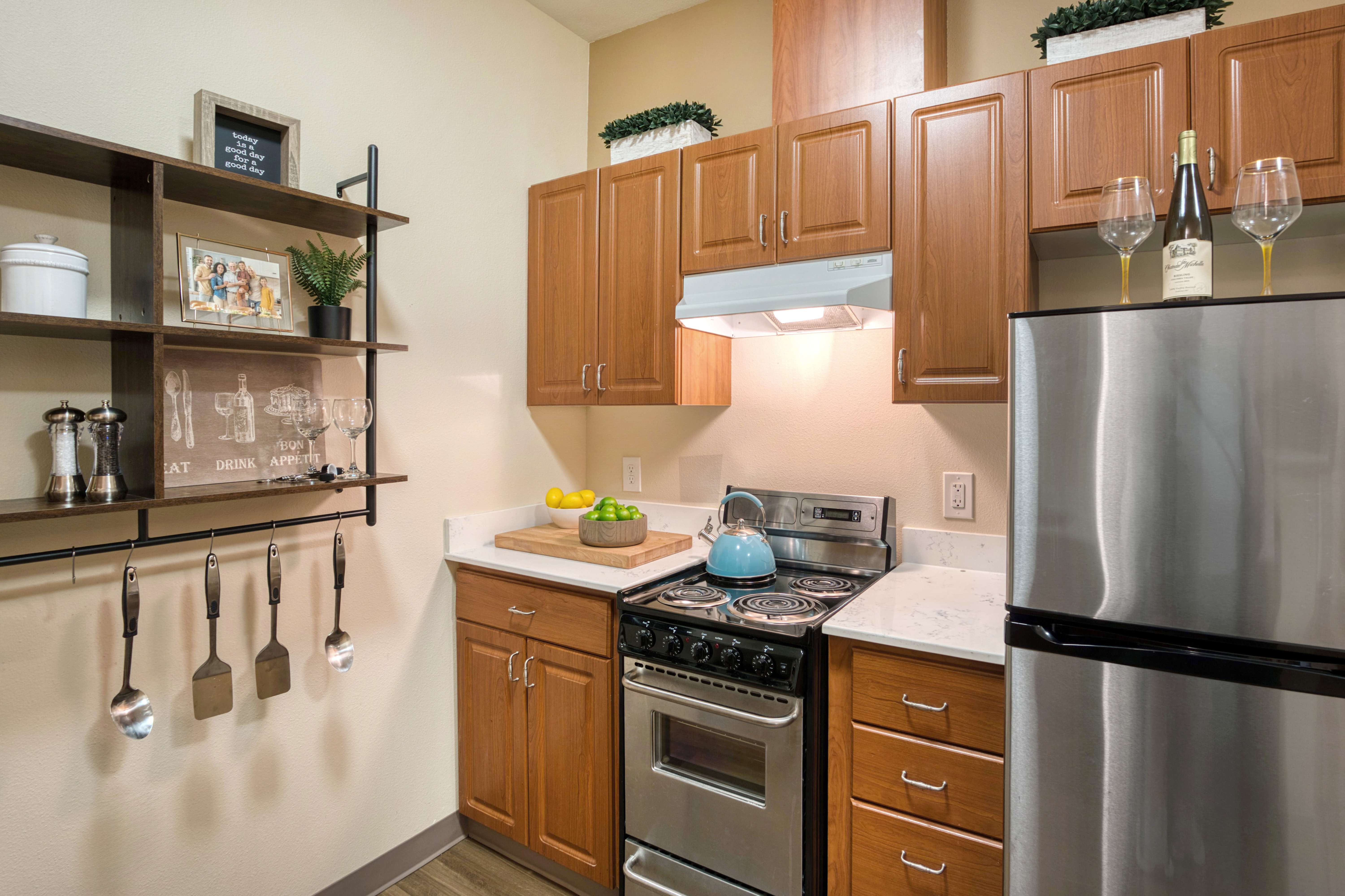 Kitchen shot with wooden cupboards and refrigerator at The Creekside in Woodinville, Washington