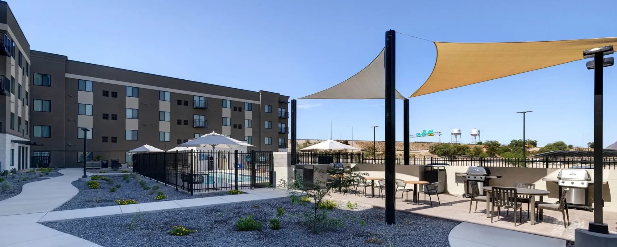 Outdoor grilling area with shaded seating at WaterWalk Huntsville in Huntsville, Alabama