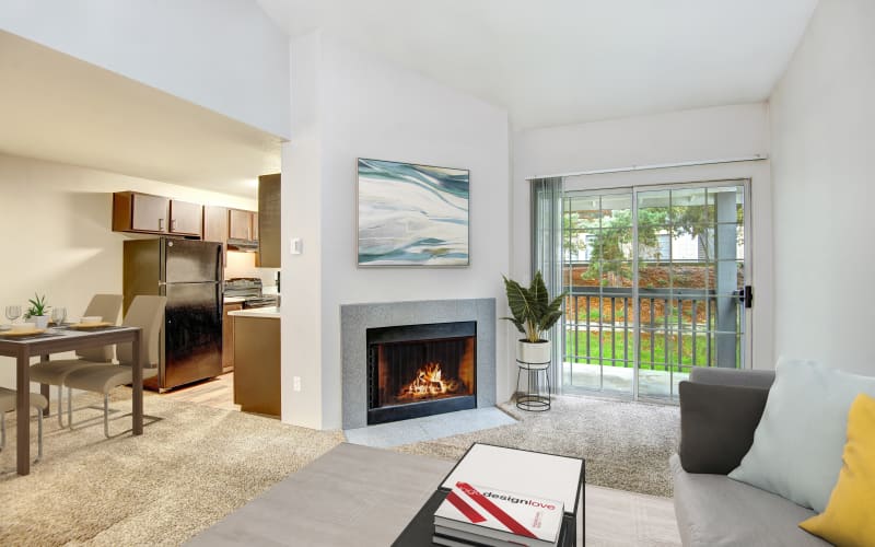 A spacious apartment with a private balcony and fireplace at Wellington Apartment Homes in Silverdale, Washington