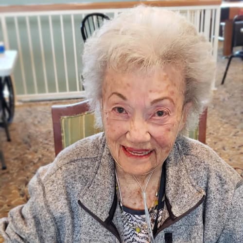 Smiling resident sitting at Canoe Brook Assisted Living & Memory Care in Catoosa, Oklahoma