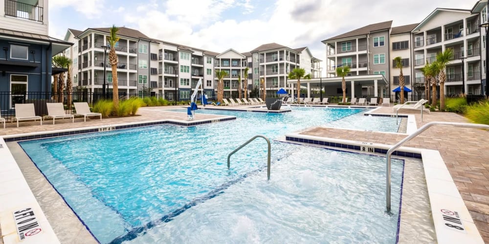 The community swimming pool between apartment buildings at Evergreen 9 Mile in Pensacola, Florida