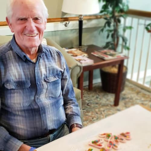 A happy resident decorating cookies at Canoe Brook Assisted Living & Memory Care in Catoosa, Oklahoma