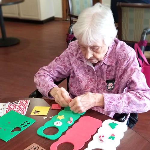 A Resident making decorative door hangers at Creekside Village in Ponca City, Oklahoma