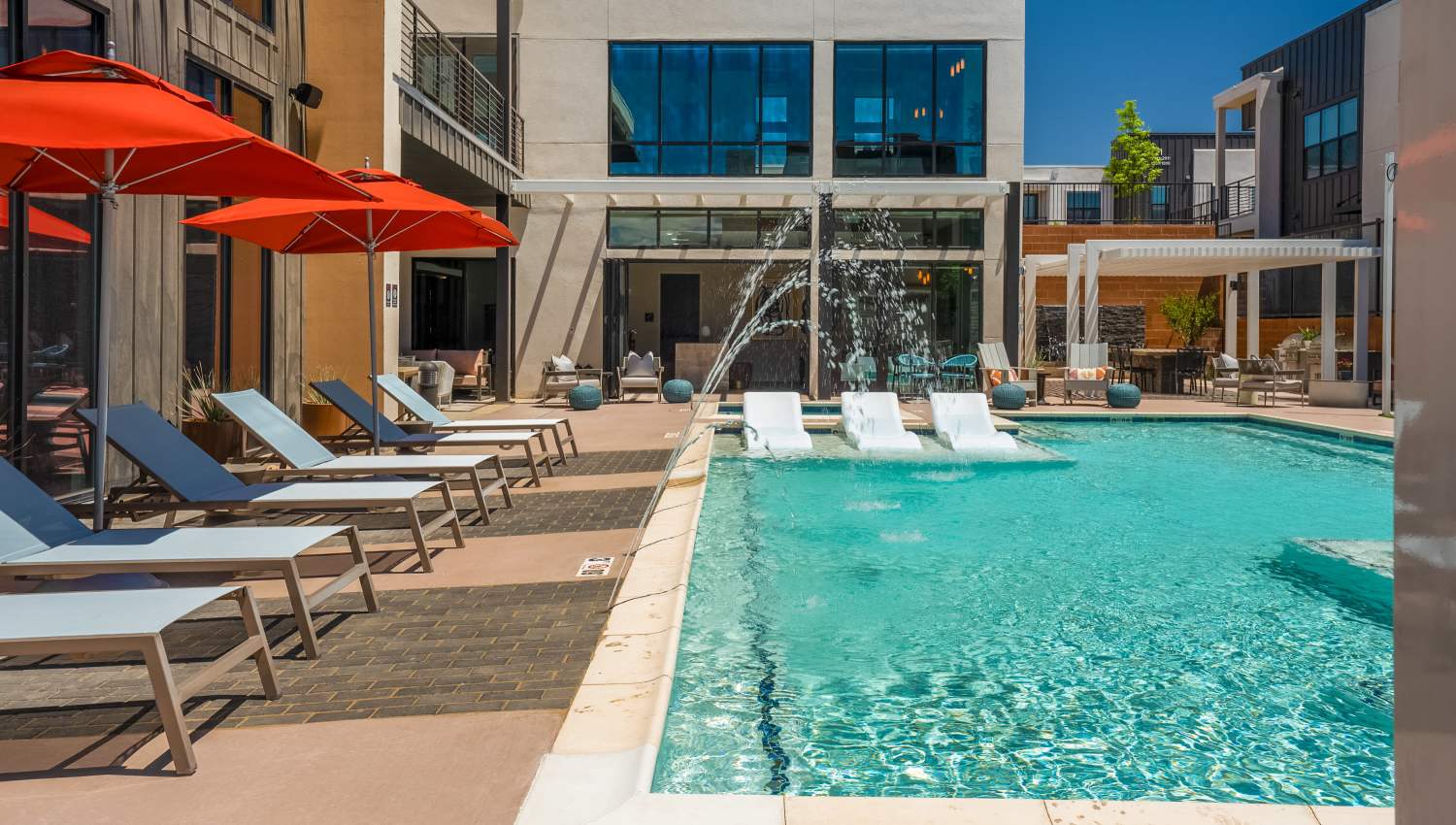 Swimming pool with lounge chairs at Olympus Latitude in Albuquerque, New Mexico