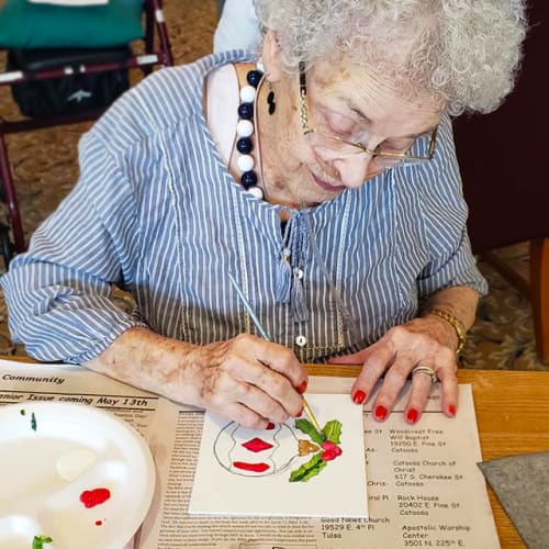 A resident painting with watercolors at Canoe Brook Assisted Living & Memory Care in Catoosa, Oklahoma