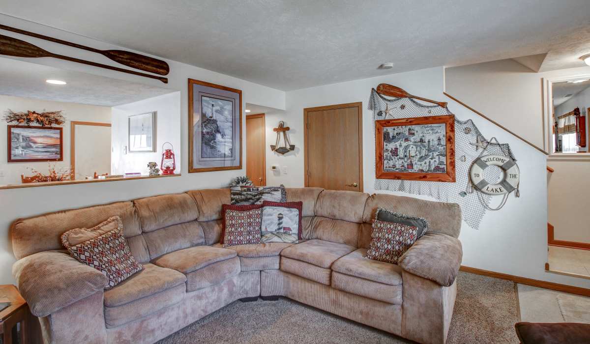 A living room with couch and chairs at Hallet Crossing in Michigan Center, Michigan
