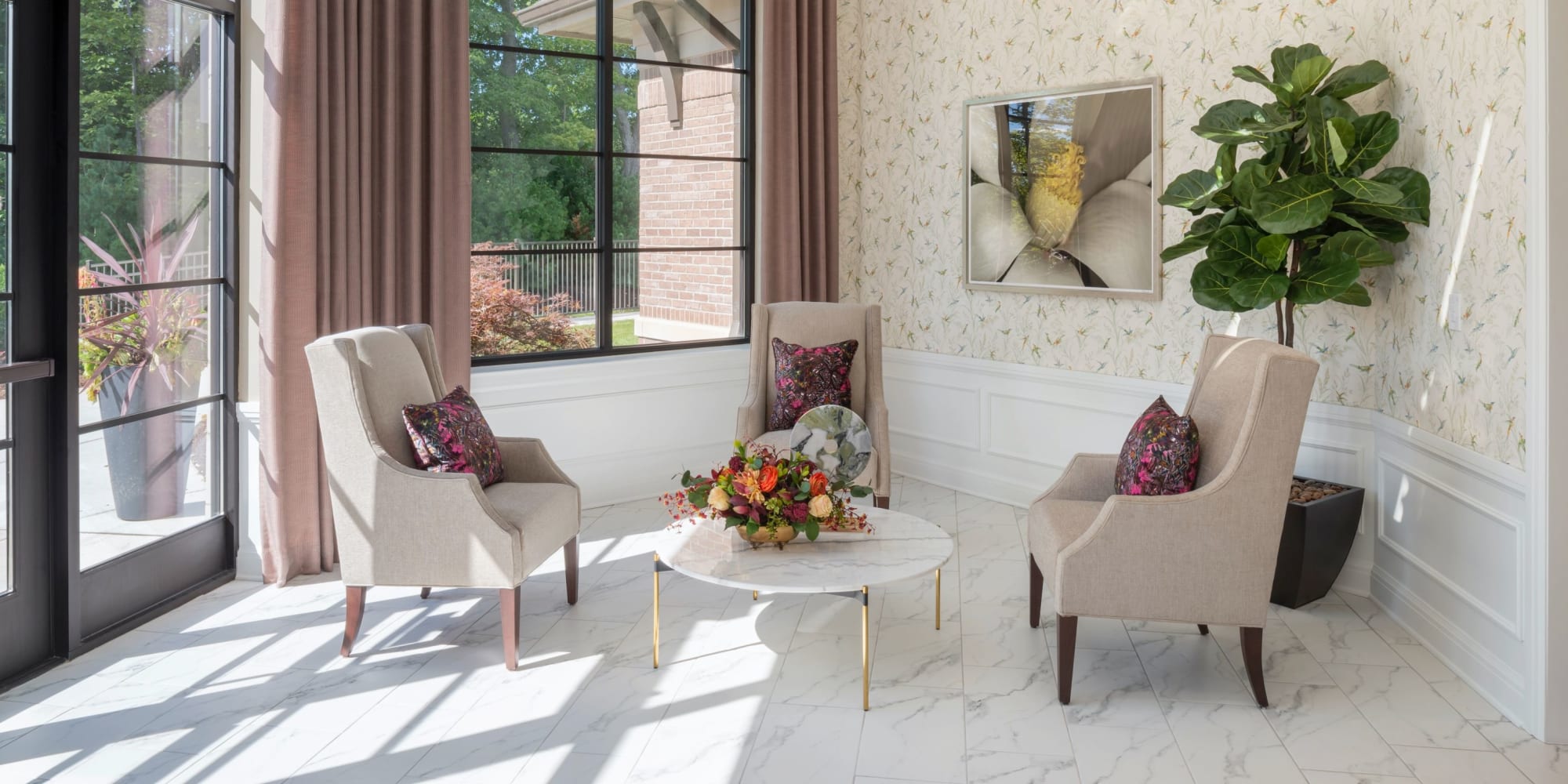 Brightly lit seating room with elegant white chairs at Blossom Springs in Oakland Twp, Michigan