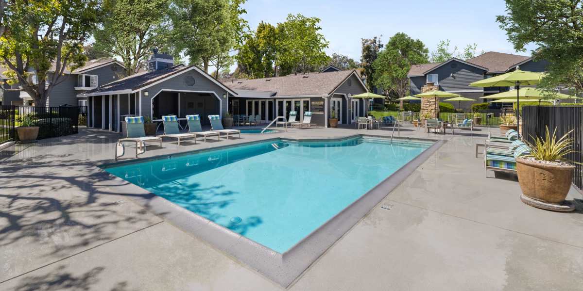 Pool with loungers and outdoor firepit at Village Oaks in Chino Hills, California
