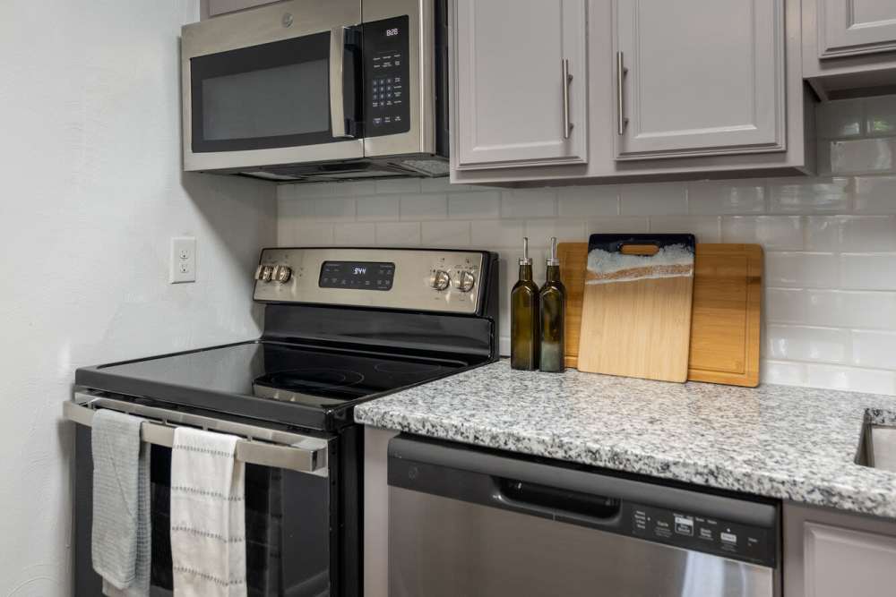 Kitchen with dishwasher and microwave at Woodmere Trace in Norfolk, Virginia