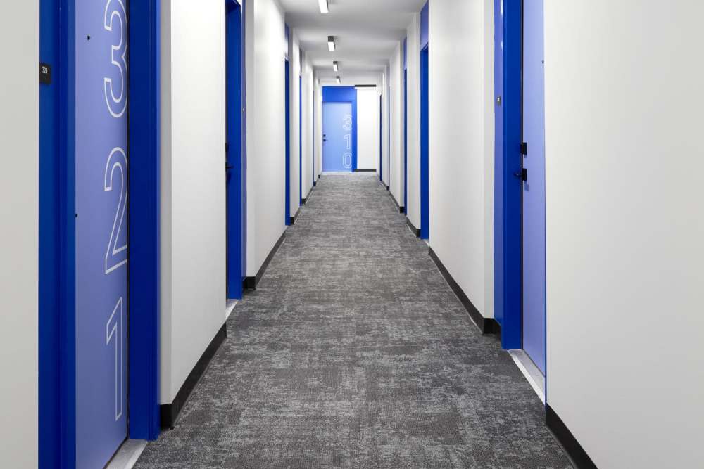 Corridor of an apartment with plush carpeting at Martin Flats in Nashville, Tennessee
