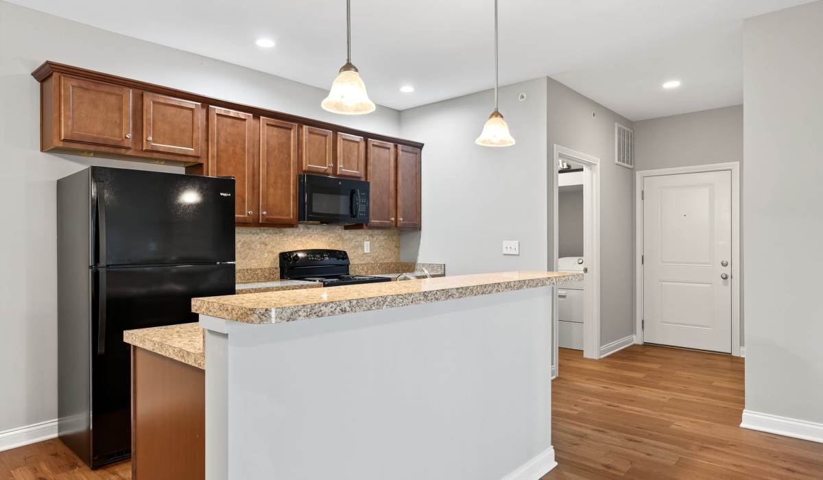 Kitchen with island countertop and wood cabinet at Palomar View Apartments in Lexington, Kentucky
