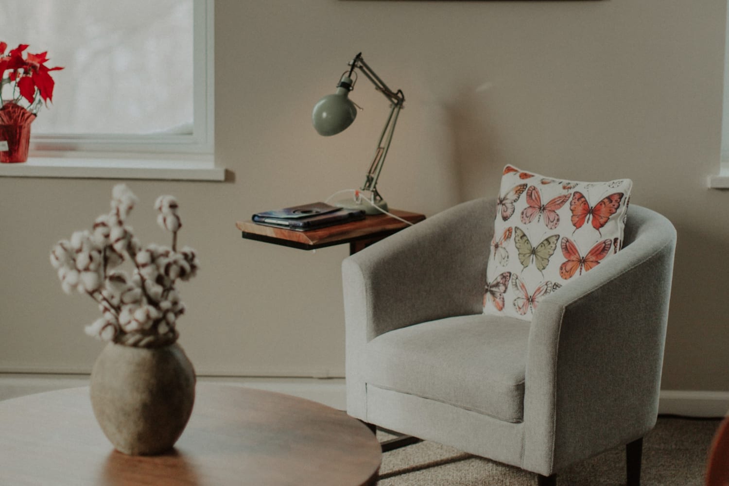 Resident living room with modern armchair and end table at The Whitcomb Senior Living Tower in St. Joseph, Michigan