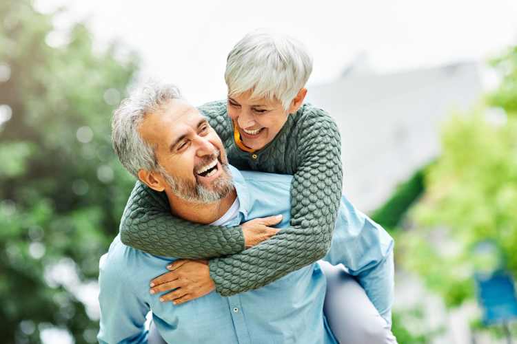 Senior couple hugging and smiling, enjoying life together at Reserve at Round Rock in Round Rock, Texas