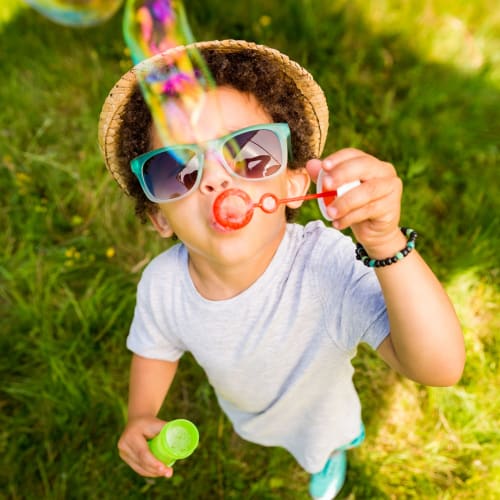 A child blowing bubbles at The 603 in Bryan, Texas