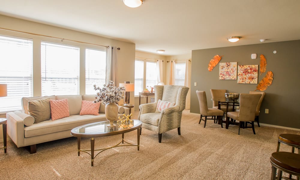 Spacious living room with plush carpeting at Icon at Broken Arrow in Broken Arrow, Oklahoma