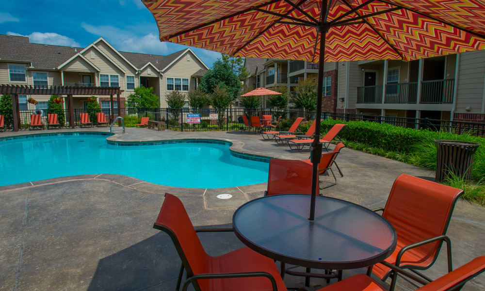 Patio seating with pool at Nickel Creek Apartments in Tulsa, Oklahoma