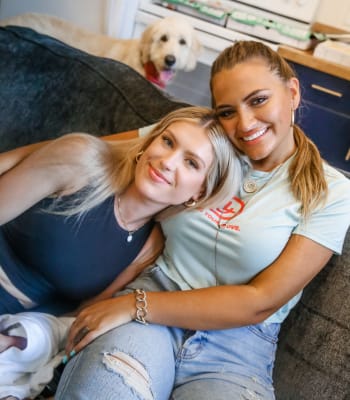 Residents together on sofa in apartment at University Lofts Downtown, Jonesboro, Arkansas