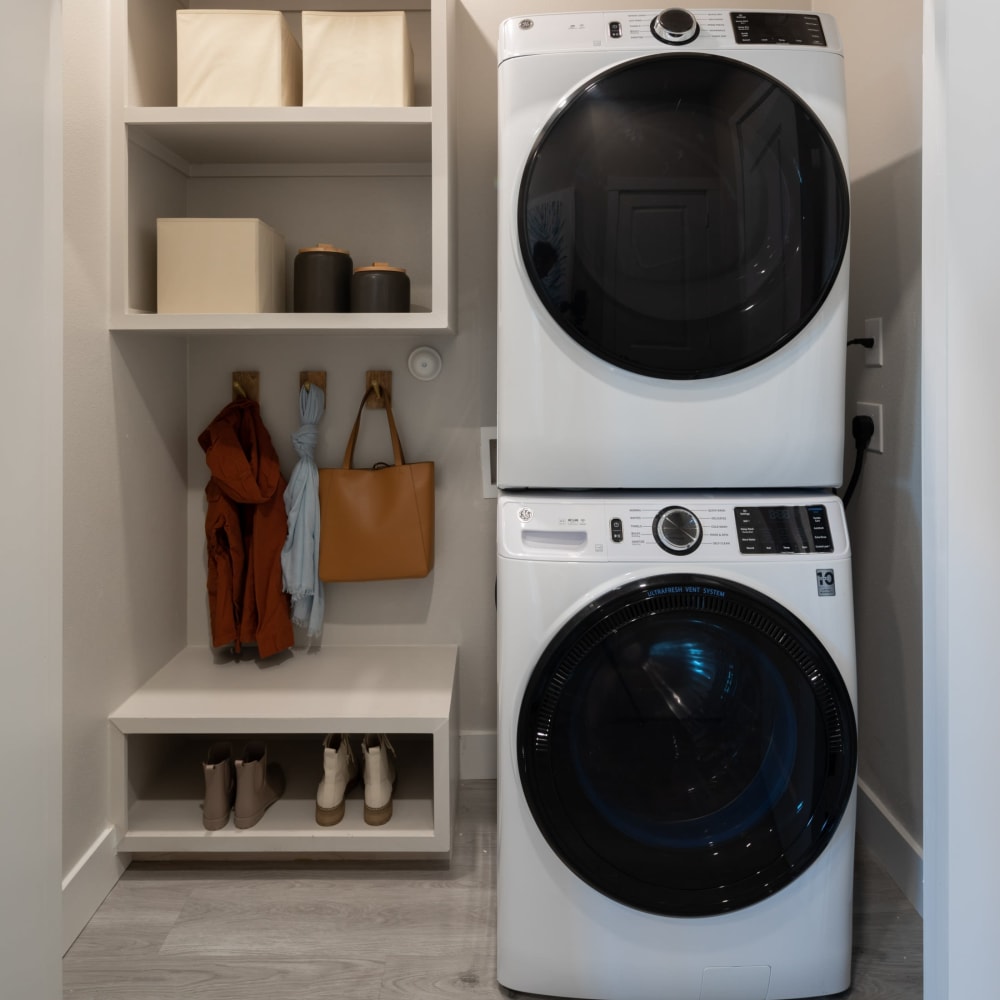 Apartment laundry room with modern washer and dryer at Bellrock La Frontera in Austin, Texas