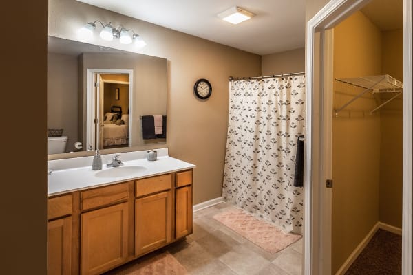 Bathroom with large vanity and shower and an oversized closet at Cobblestone Crossings in Terre Haute, Indiana