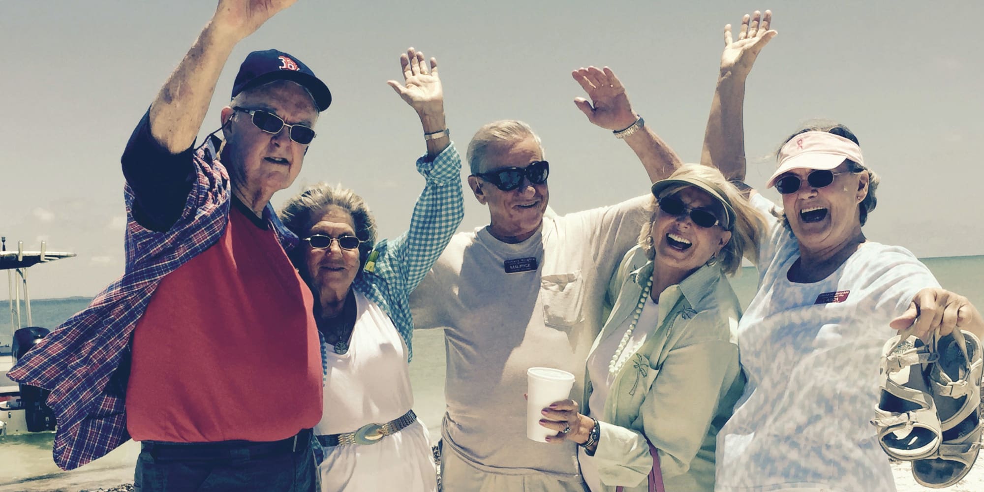 A group of residents from Orchard Heights Gracious Retirement Living in Clermont, Florida by the water