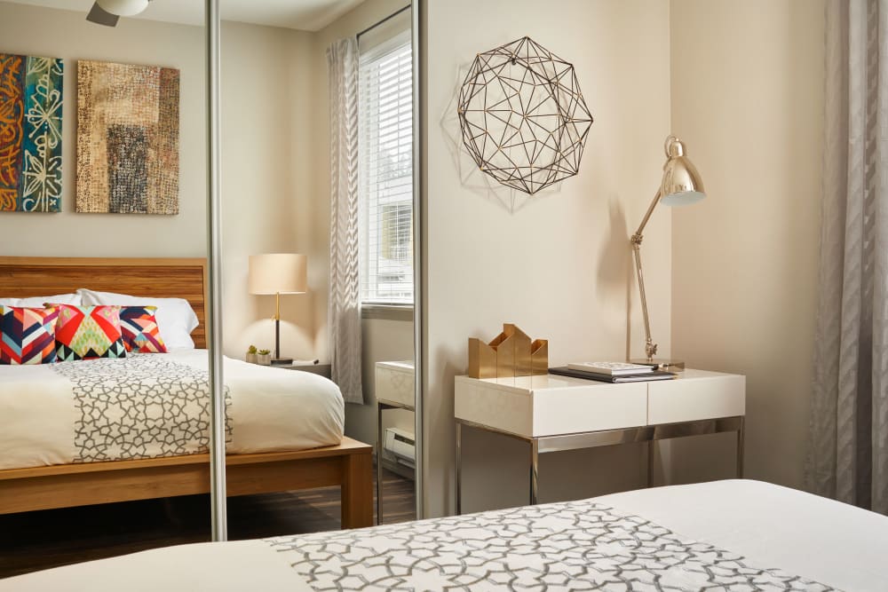 Large bedroom with mirrors on the closet doors at Brookside Village in Auburn, Washington