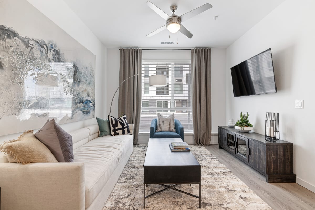 Living room with wood style flooring at Marq Promenade in Westminster, Colorado