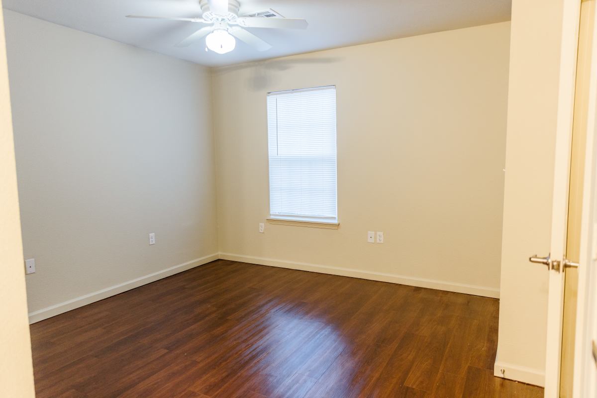 Apartment bedroom with ceiling fan at Pheasant Run in Enid, Oklahoma