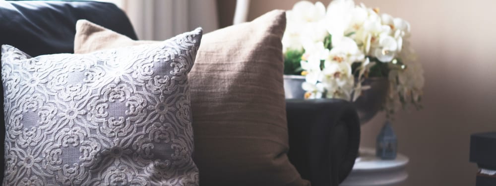 Cozy cushions adorn a couch at Lakefront on Washington in Seattle, Washington