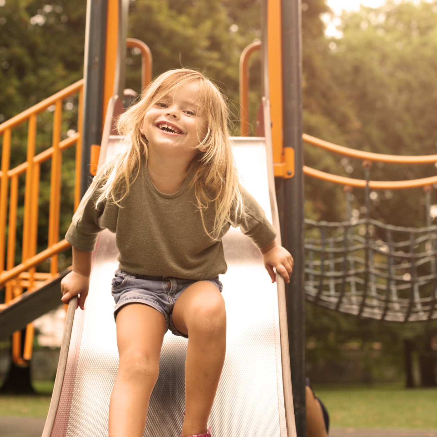 Girl having fun at a playground in Gaithersburg, MD near Stewartown Homes