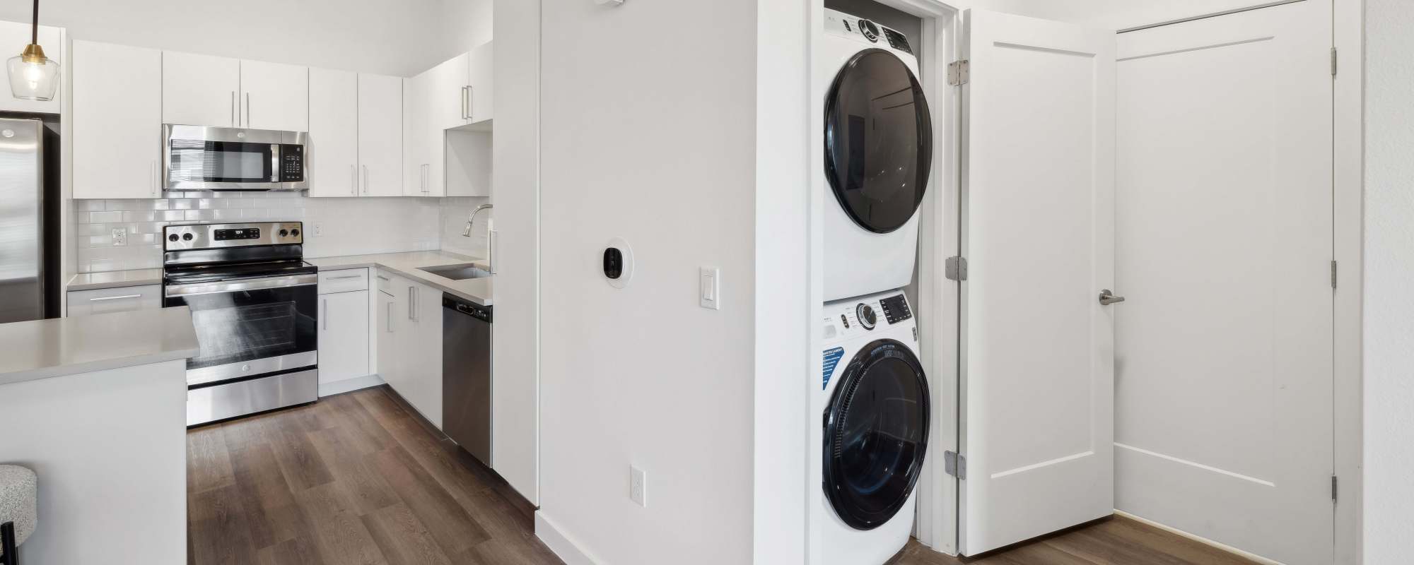 Washer and dryer with access to kitchen at Residences Of Highland in Hialeah, Florida