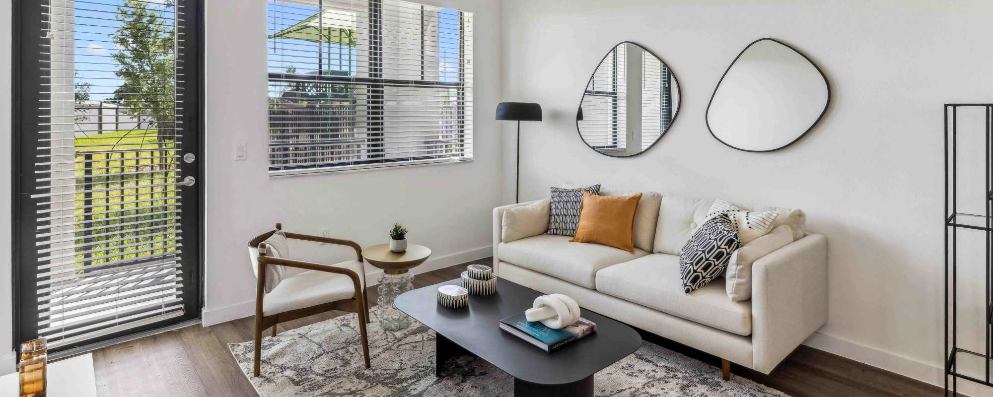 Bright living room with access to balcony at Residences Of Highland in Hialeah, Florida