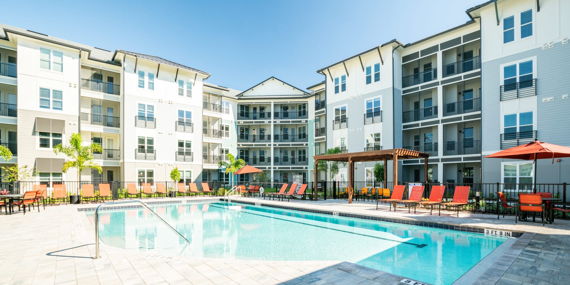 Swimming pool and exterior of building at The Pointe at Siena Ridge in Davenport, Florida